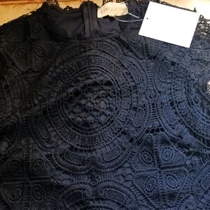 Ladies sleeveless black blouse with zipper in the back and is also lined